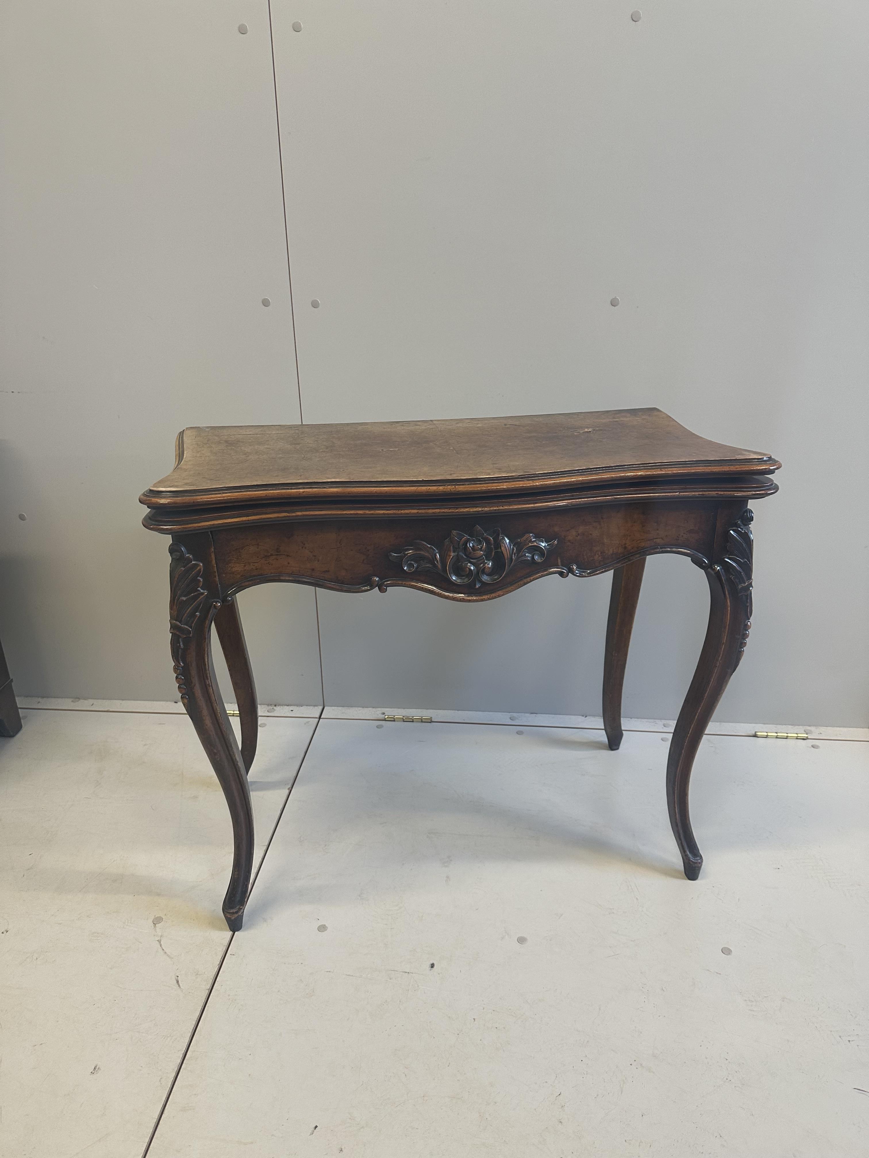 A Victorian burr walnut serpentine folding card table, width 84cm, depth 42cm, height 73cm